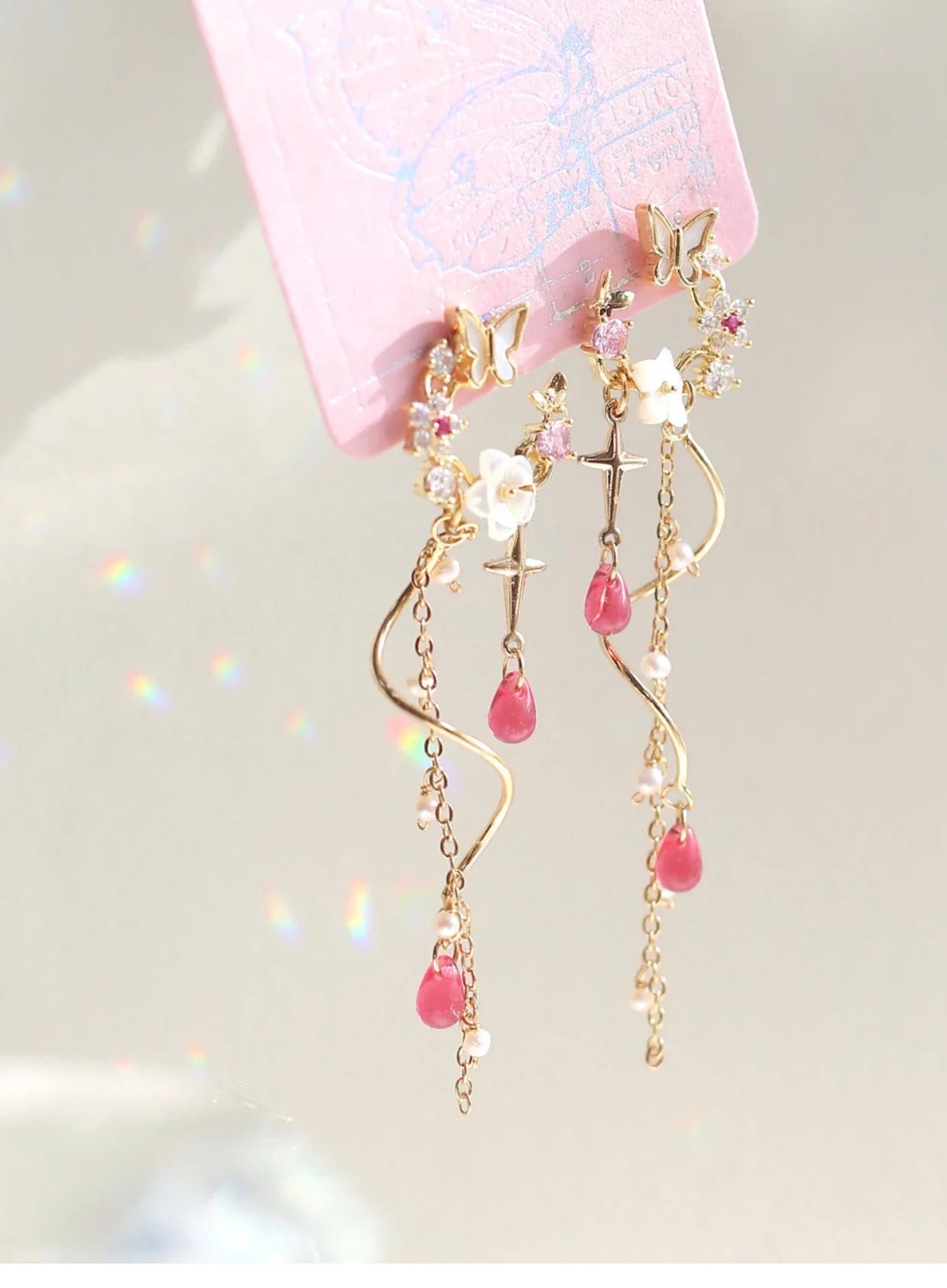 Elegant sterling silver and gold-plated earrings adorned with iridescent freshwater pearls