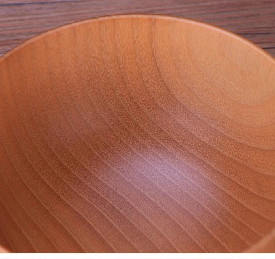 A large, round wooden soup bowl with a warm, natural brown color, perfect for serving hearty meals in Kiwi kitchens.