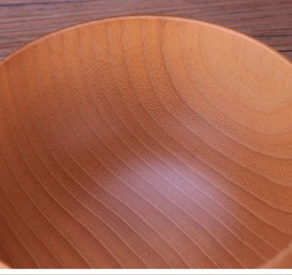 A large, round wooden soup bowl with a warm, natural brown color, perfect for serving hearty meals in Kiwi kitchens.