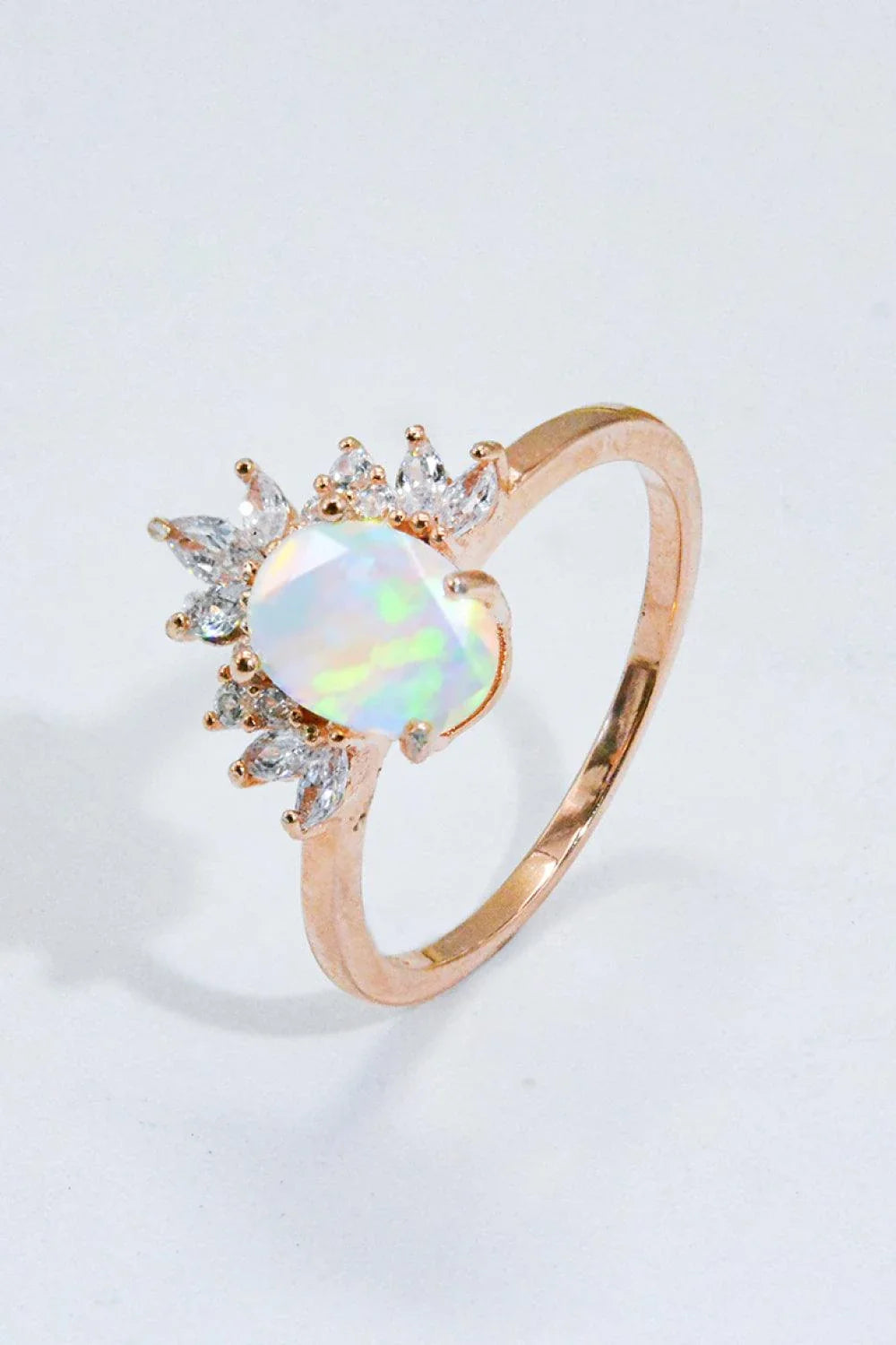 A close-up view of a 925 sterling silver ring featuring a shimmering opal stone, showcasing the modern and sustainable design.