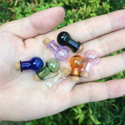 Multicoloured mini glass bottles in a stylish ball shape, perfect for essential oils, trinkets, and decorative accents.