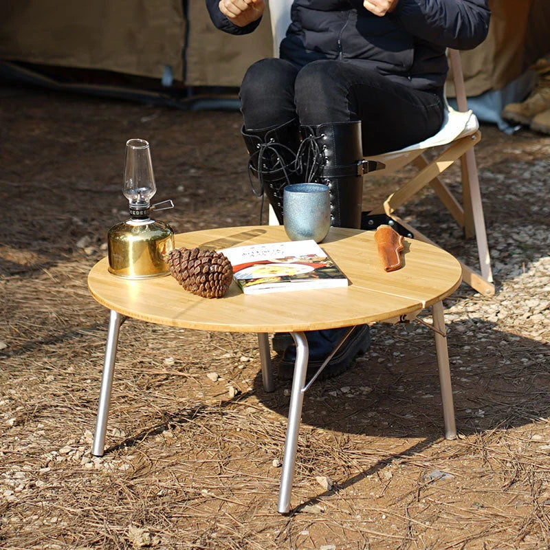 Portable bamboo folding table with stainless steel frame, ideal for outdoor activities like camping, picnics, and BBQs in New Zealand