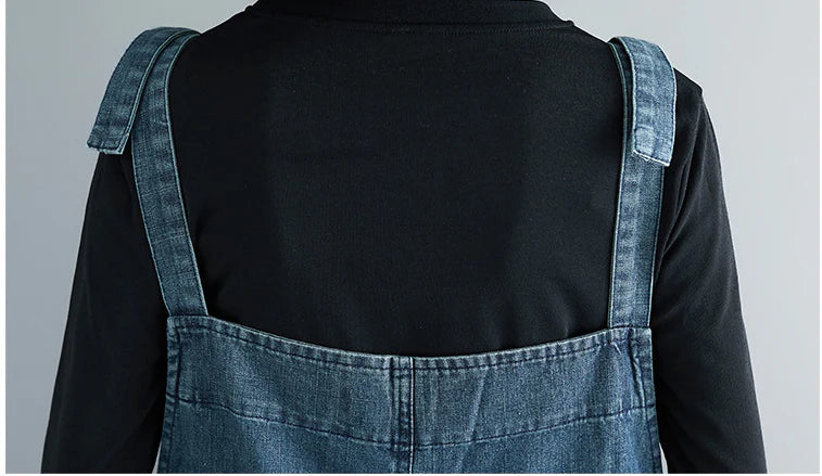 Women's plus-size denim overalls featuring a sustainable, high-waist design with distressed detailing