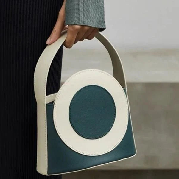 Stylish vegan leather colour block bucket bag with adjustable strap, perfect for modern Kiwi lifestyles