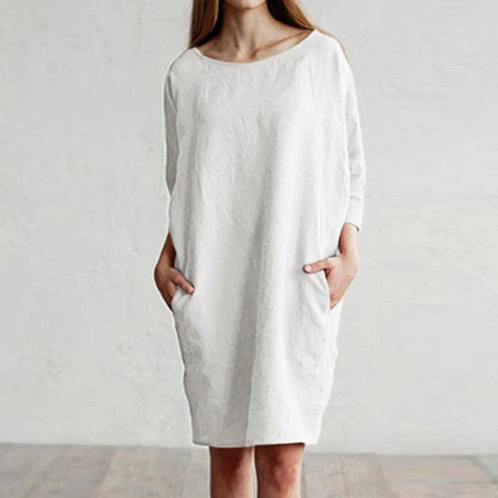 A cotton and linen dress with a round neckline, pockets, and an A-line silhouette in various colors.