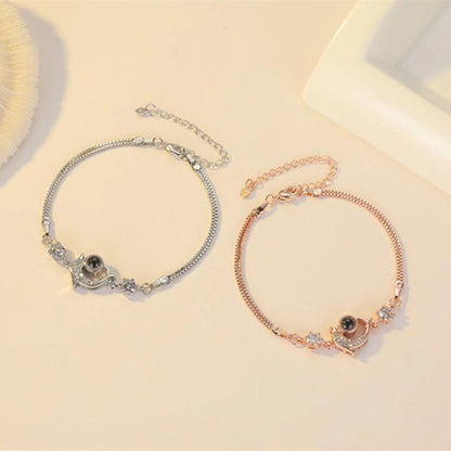 A pair of vibrant projection couple bracelets in rose gold and platinum colors
