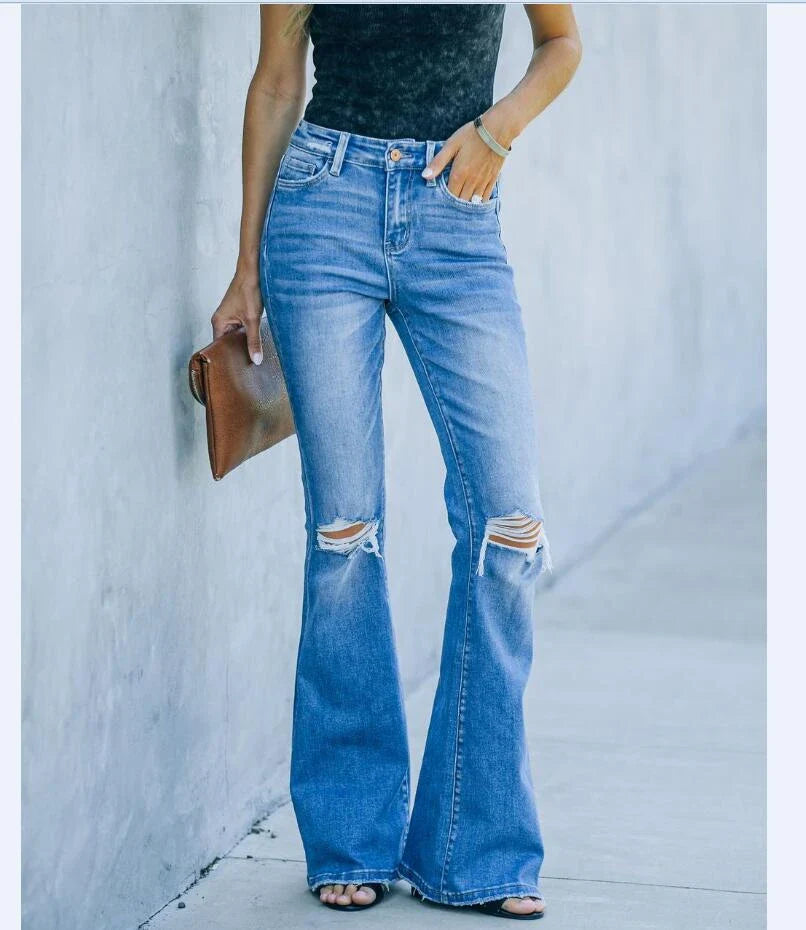 Stylish women's denim trousers with ripped and washed details, perfect for casual or dressy occasions