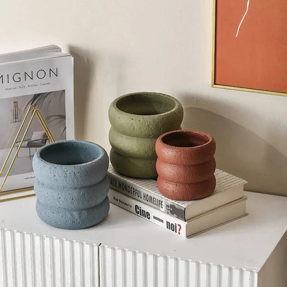 Stylish modern minimalist cement flower pots in two sizes, perfect for showcasing plants and greenery in a Kiwi home