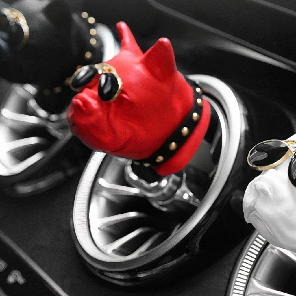 Vibrant red car air freshener in the shape of a bulldog with painted aviator shades and collar