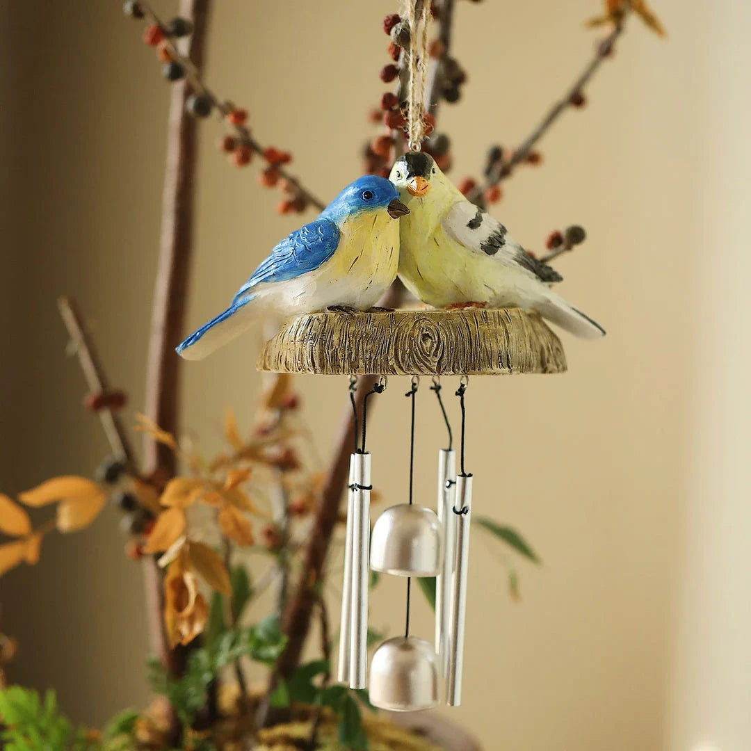 Charming wind chime featuring resin birds in vibrant Kiwi colours, swaying gently in the breeze and emitting a melodious sound.