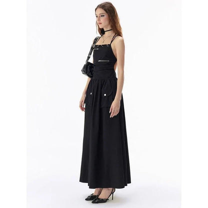 Elegant black backless maxi dress with pockets, perfect for formal events or casual outings.