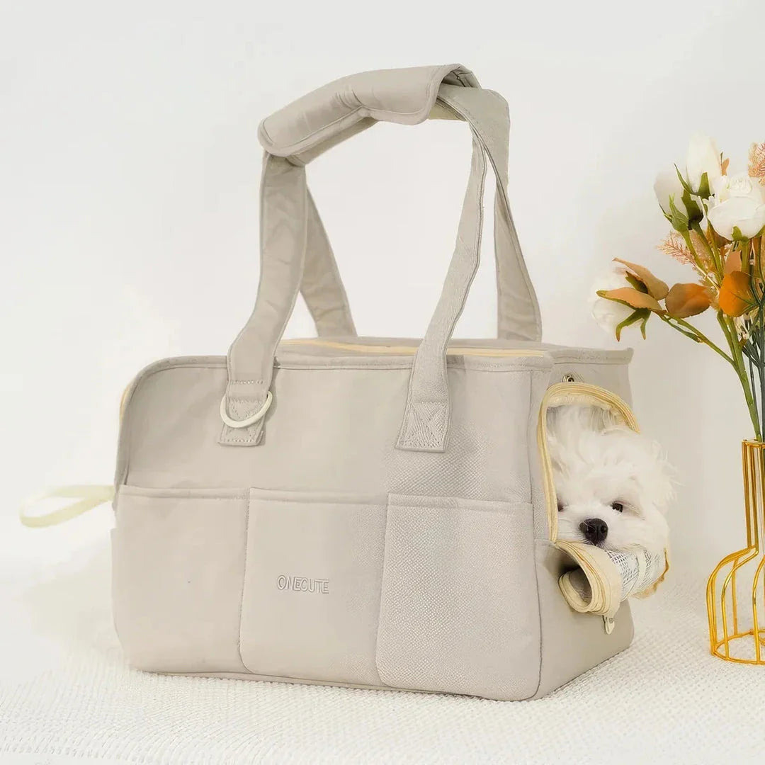 A stylish and practical cotton shoulder bag carrier for small dogs, with a hard board base and cozy interior for comfort and security during adventures.