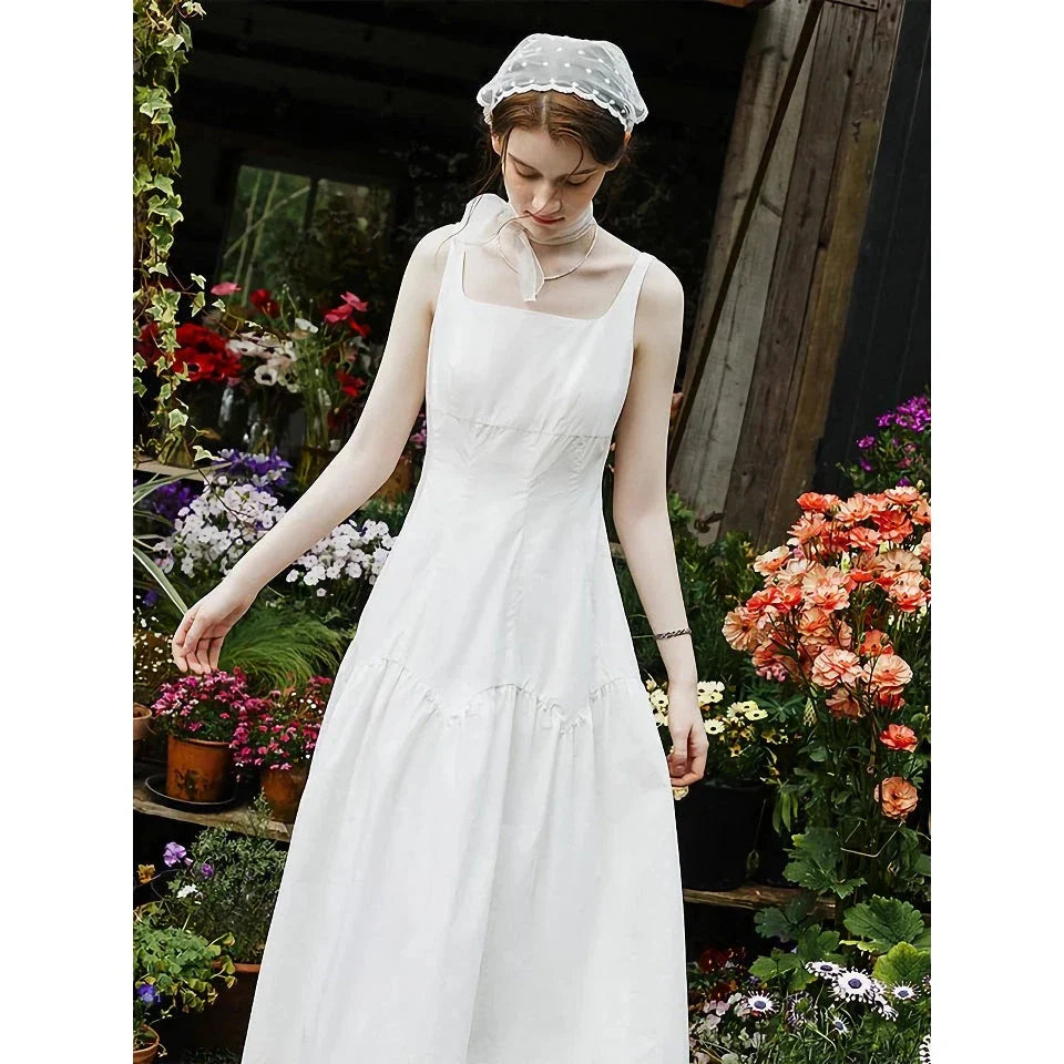 A French-inspired white suspender long dress made of 100% premium cotton for effortless elegance and all-day comfort.