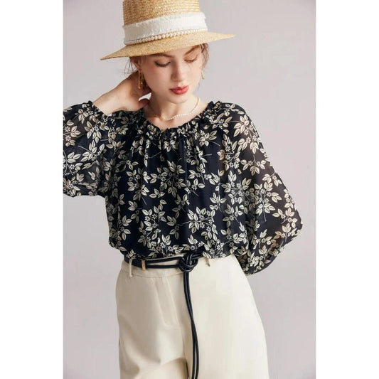 Elegant floral silk-blend blouse with ruffled details and relaxed raglan sleeves