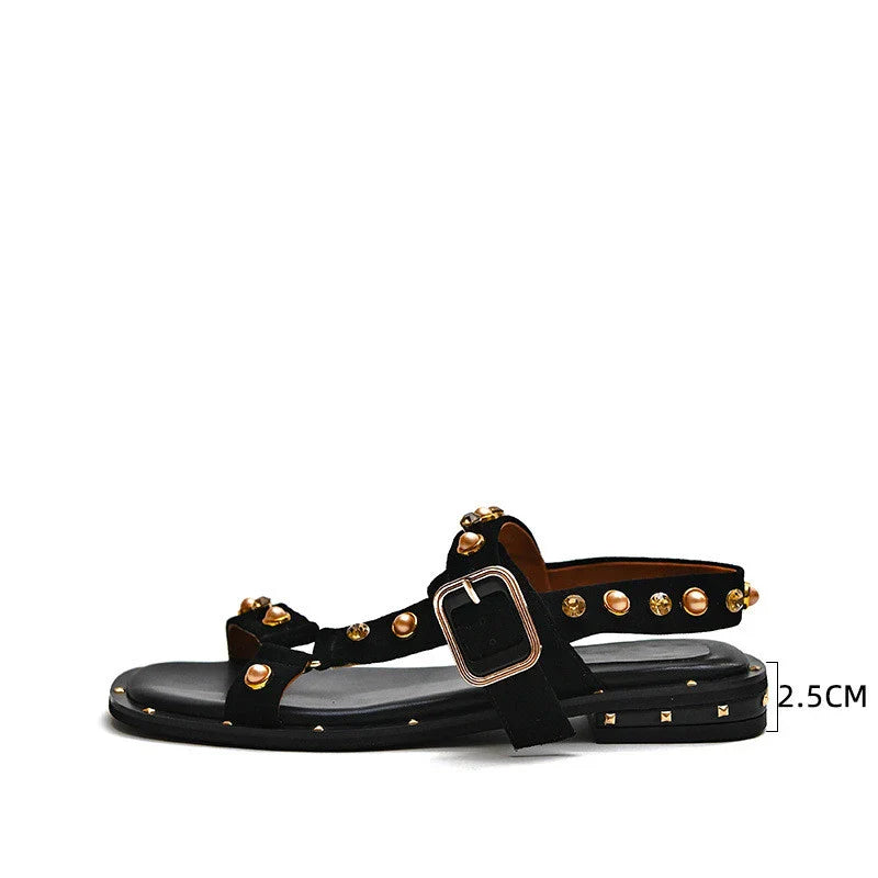 Black flat sandals with orange accents, inspired by the Roman holiday style, perfect for Kiwi women's warm-weather fashion