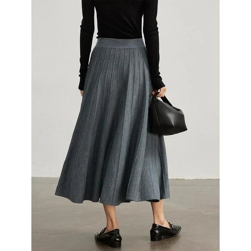 A stylish and versatile mid-calf pleated wool skirt in a chocolate color, perfect for the chilly seasons.