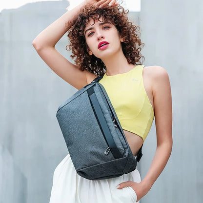 A grey one-shoulder crossbody chest bag with a zippered closure and dedicated pockets for the modern, active Kiwi man