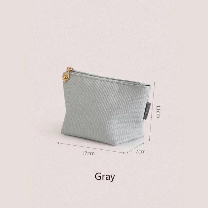 Compact and versatile mini cosmetic pouch in beige and gray colours, perfect for New Zealand travellers