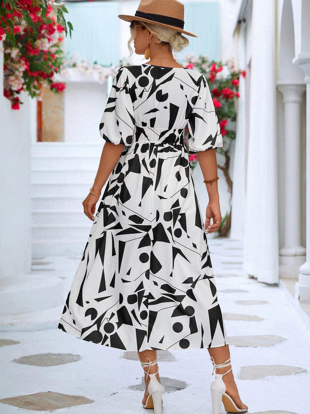 A stylish puff-sleeve dress with a printed surplice neckline, perfect for casual and dressy occasions.