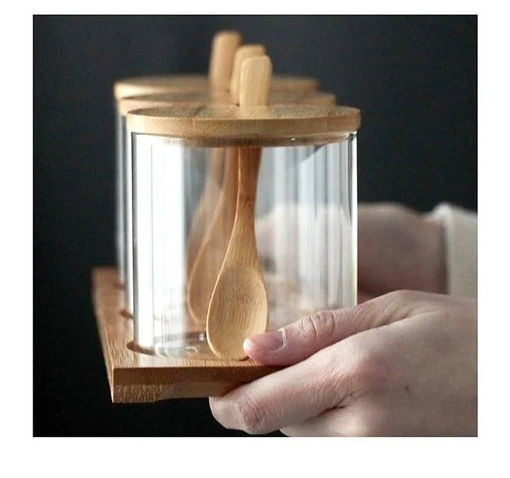 Glass and timber storage jars set with spoons, perfect for organizing and storing pantry items in style