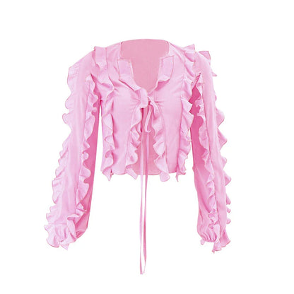 A pink ruffled crop top with a heart-shaped bow accent, made from stretch chiffon fabric for the modern Kiwi girl's style.