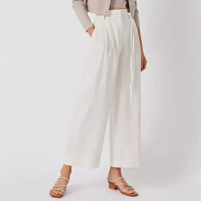 Elegant high-waist linen trousers with Korean-inspired design, featuring lace-up detail and button decorations for a sophisticated and comfortable look.