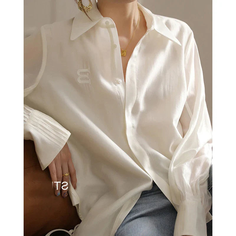 A stylish and comfortable white chiffon blouse for Kiwi women, featuring a classic cardigan design and versatile, high-quality construction.