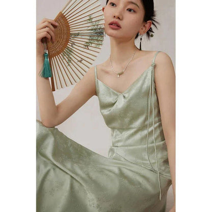 Elegant and stylish mint green midi dress with spaghetti straps, perfect for summer events and occasions.