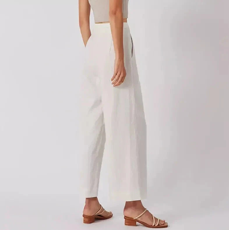 Elegant high-waist linen trousers with Korean-inspired design, featuring lace-up detail and button decorations for a sophisticated and comfortable look.