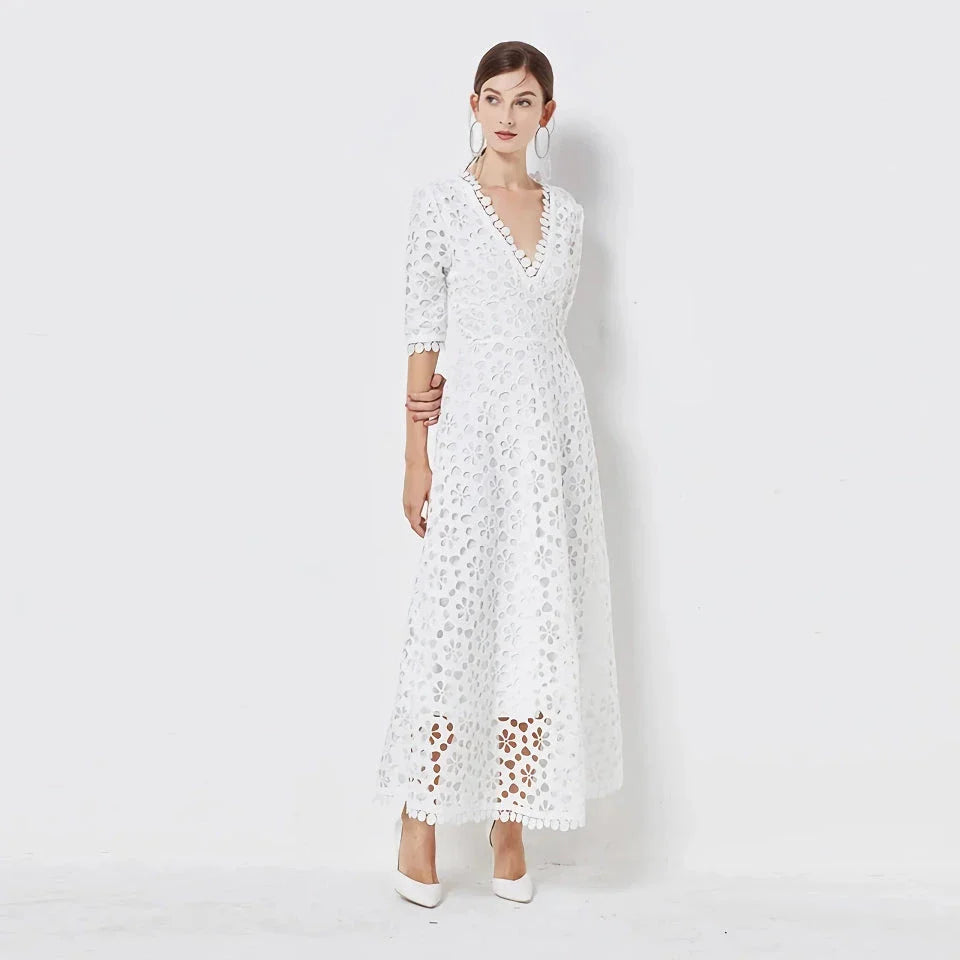 A white lace maxi dress with a stylish V-neck design, perfect for special occasions.