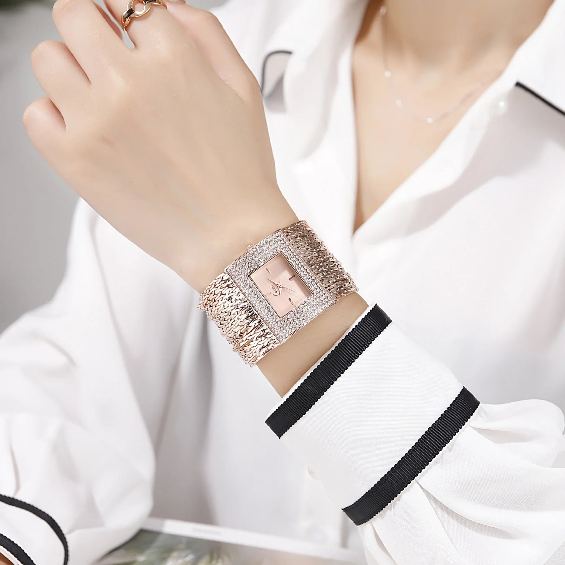 A gold-toned ladies' quartz watch with a rhinestone-encrusted face and a comfortable alloy strap