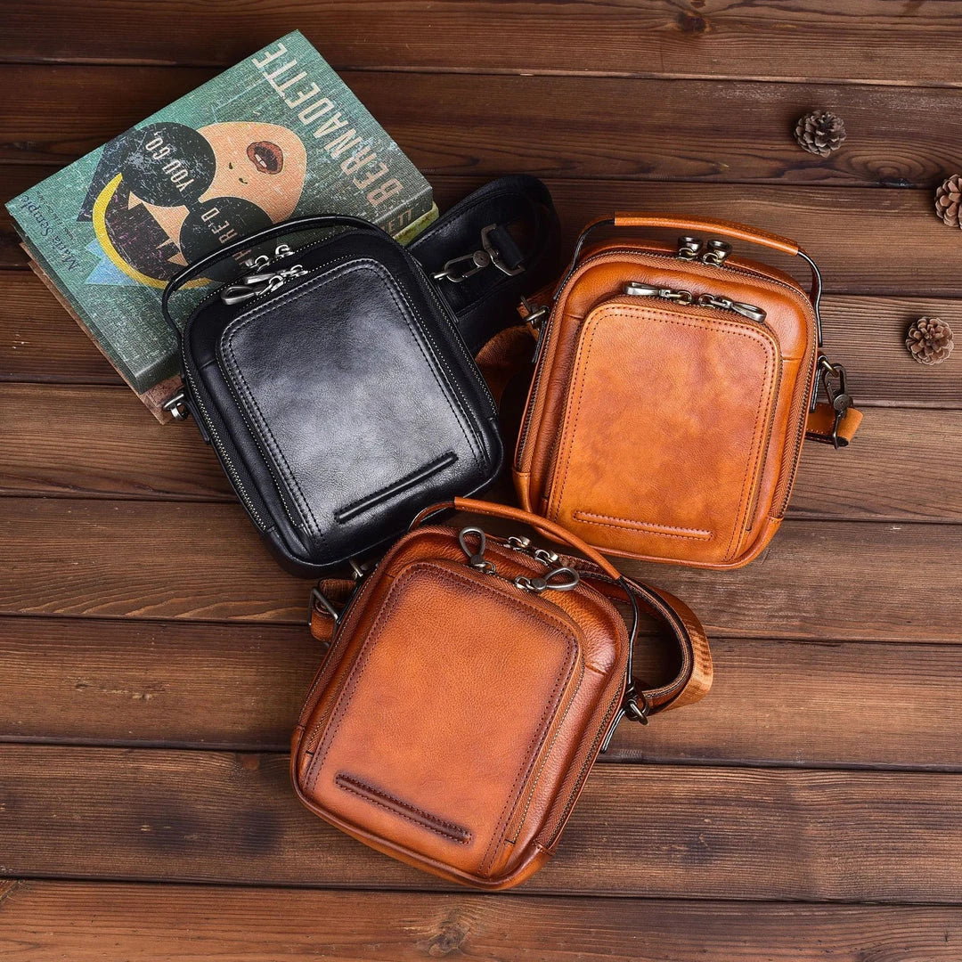 A rugged, retro-inspired cowhide messenger bag made in New Zealand, featuring a spacious interior, multiple pockets, and a comfortable single strap design.