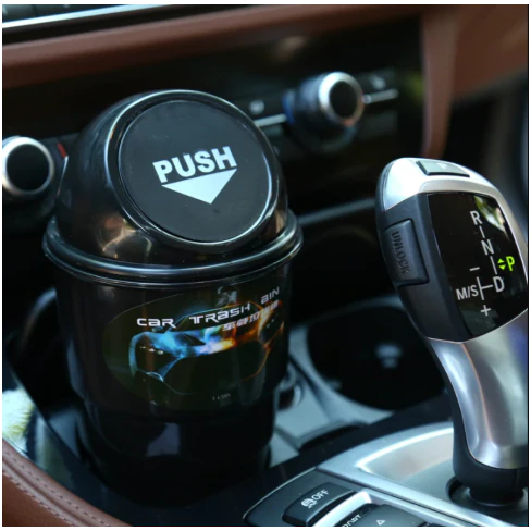 Compact in-car rubbish bin made of durable ABS plastic, designed to fit in car cup holders and keep vehicles clean and organised