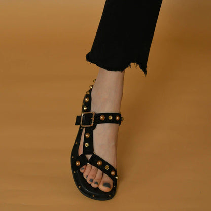 Black flat sandals with orange accents, inspired by the Roman holiday style, perfect for Kiwi women's warm-weather fashion