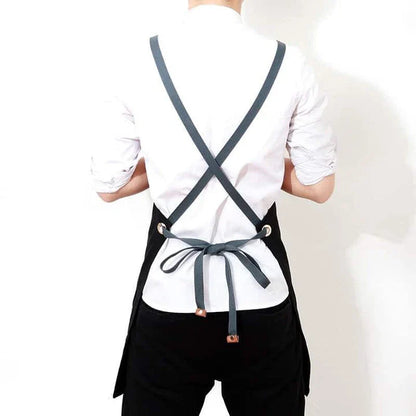 Black canvas barista apron with multiple pockets and adjustable straps, perfect for Kiwi café workers