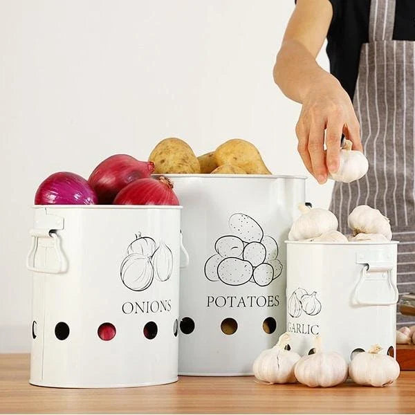 Breathable metal storage bins with handles for storing fresh produce like onions, potatoes and garlic in the kitchen.