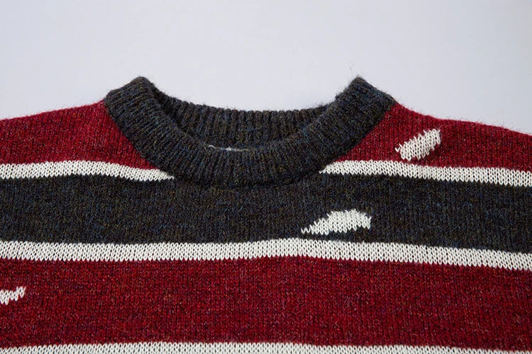 A vibrant red pullover sweater with an eye-catching patchwork stripe pattern, a cozy and stylish Kiwi wardrobe essential.