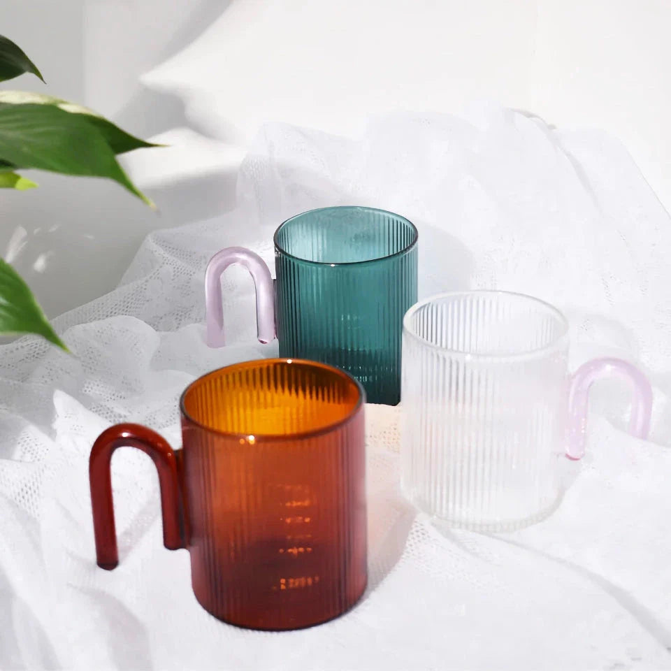 Stylish heat-resistant glass mug with vibrant colourful handle, perfect for hot beverages