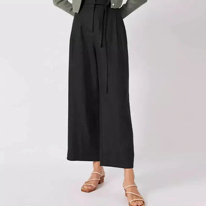 Elegant high-waist linen trousers with Korean-inspired design, featuring lace-up detail and button decorations for a sophisticated and comfortable look.