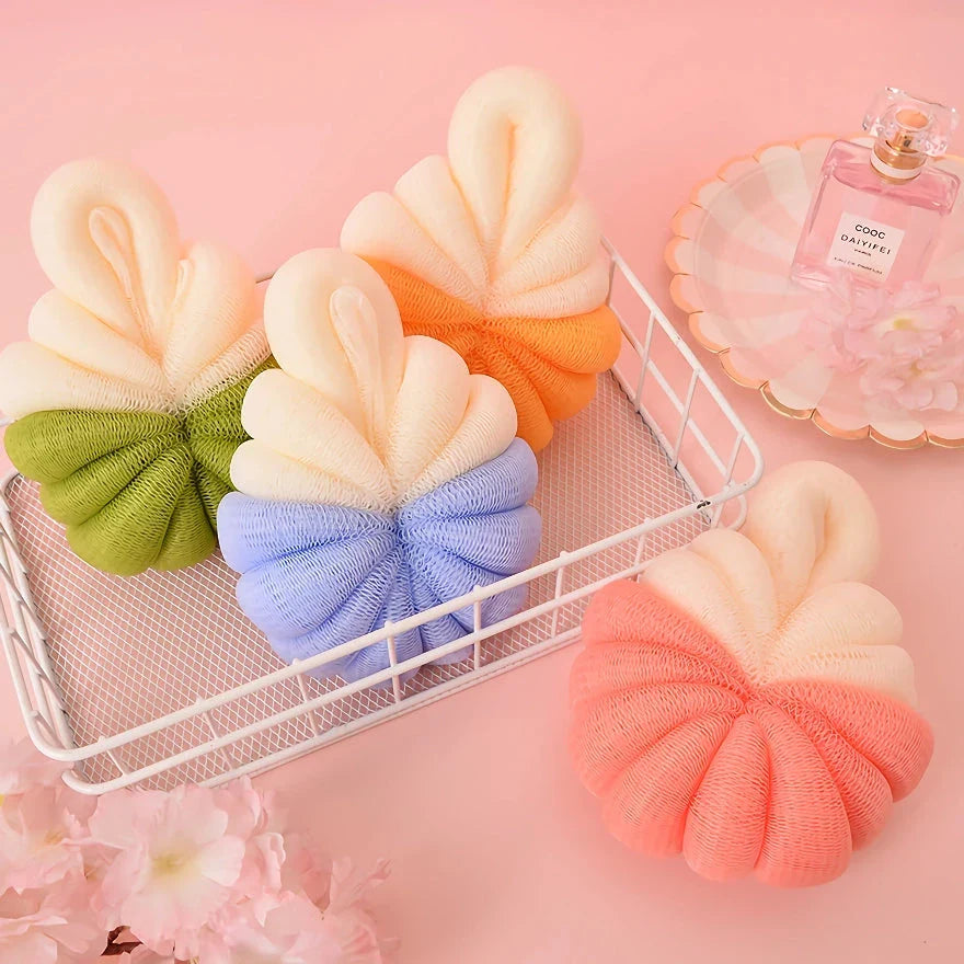 Stylish pumpkin-shaped bath sponges in pink, designed to provide a luxurious and rejuvenating bathing experience