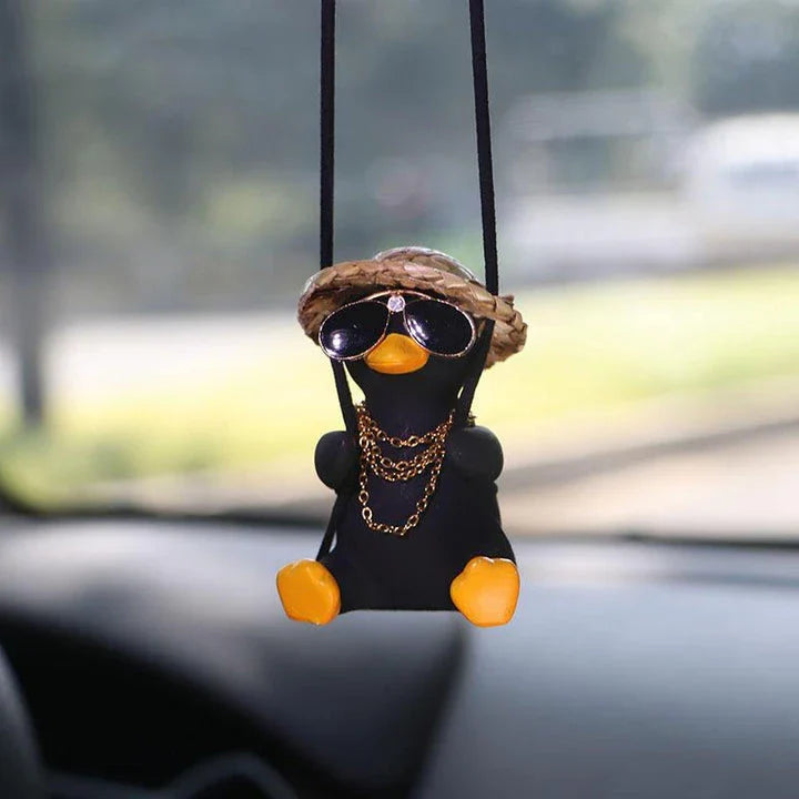 A charming swinging duck car pendant with a guitar and coke-themed design, adding a touch of Kiwi personality to your vehicle.