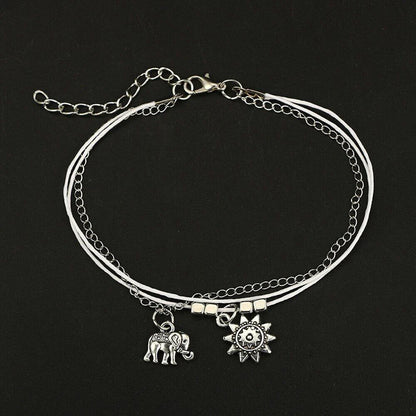 Bohemian-style anklet with star and elephant pendant charms, made from durable zinc alloy in shimmering silver and gold tones