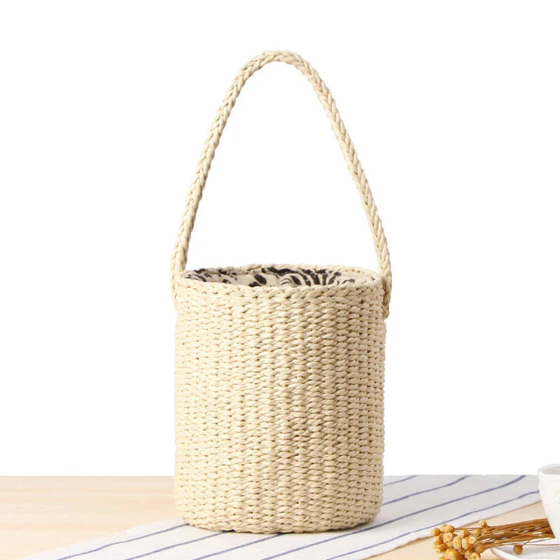 Hand-crafted straw bucket bag in camel and beige colors, featuring a compact and lightweight design for everyday Kiwi summer use