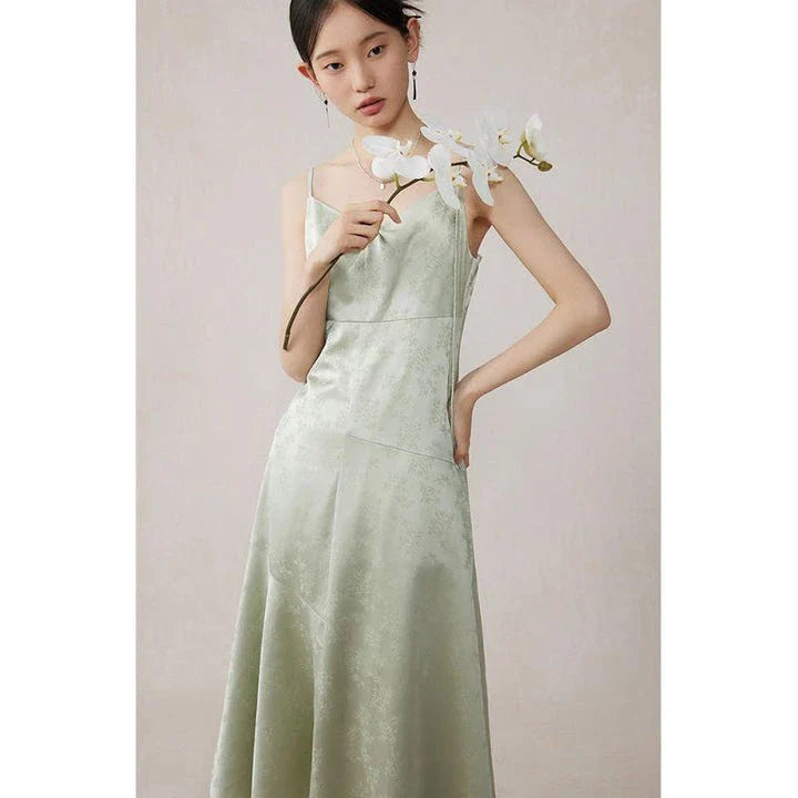 Elegant and stylish mint green midi dress with spaghetti straps, perfect for summer events and occasions.