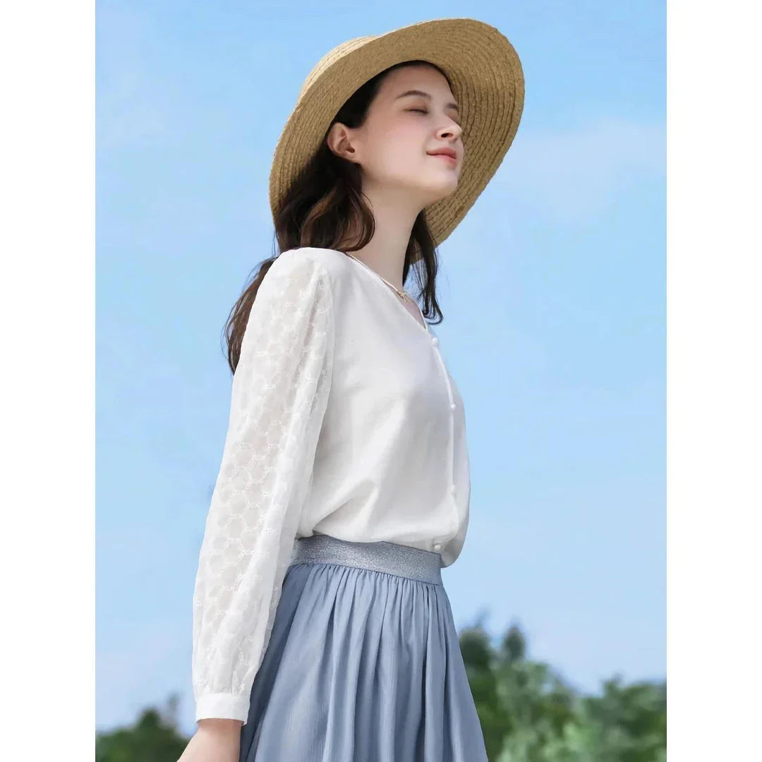 Elegant and versatile French-inspired women's blouse in a classic white color