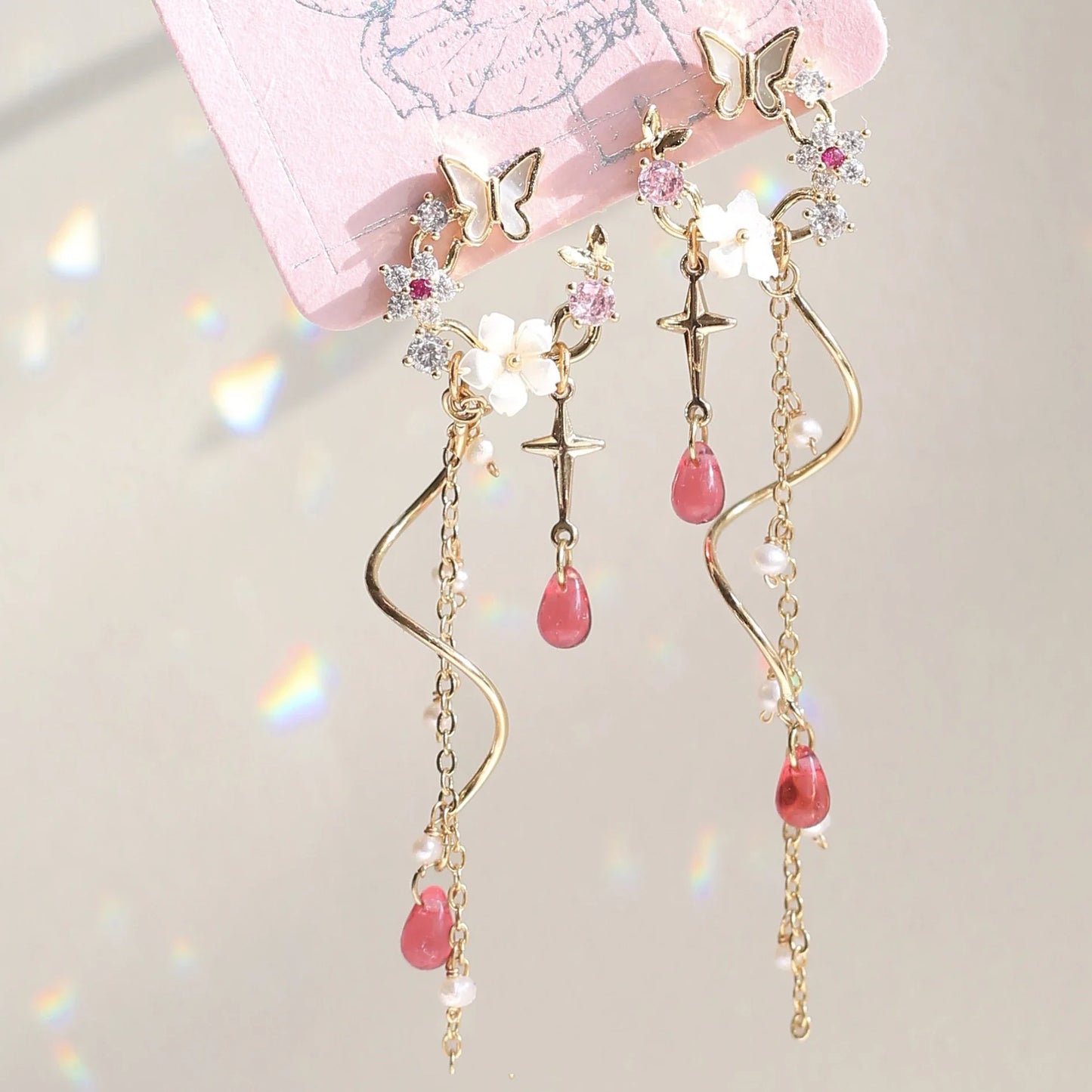 Elegant sterling silver and gold-plated earrings adorned with iridescent freshwater pearls