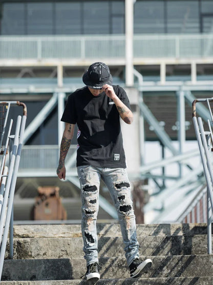 Vintage-inspired jeans with rhinestone and ink splash detailing, perfect for the modern Kiwi lifestyle