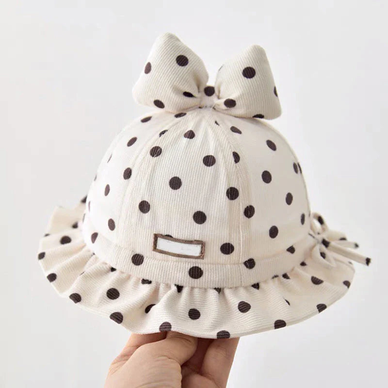 Stylish corduroy baby bucket hat with adorable dot pattern and bow detail, perfect for Kiwi kids