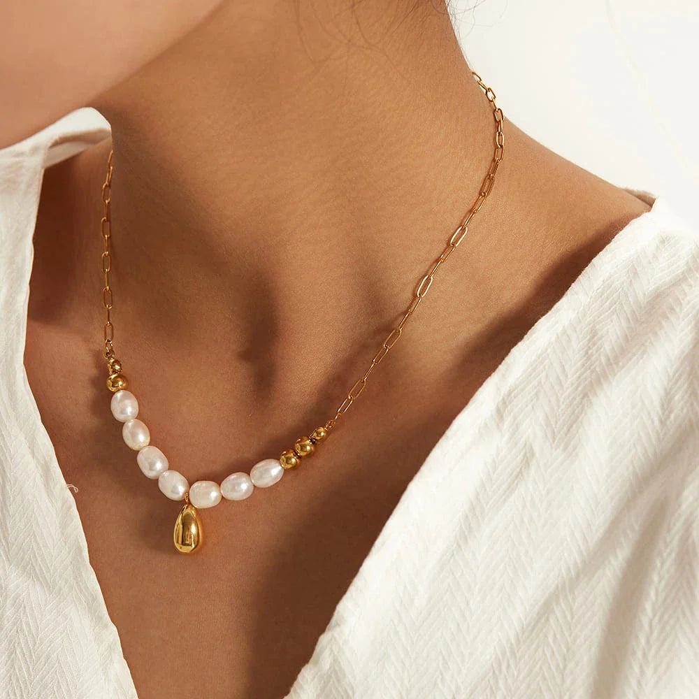 Elegant pearl and gold pendant necklace with a delicate gold drop, a timeless accessory for New Zealanders