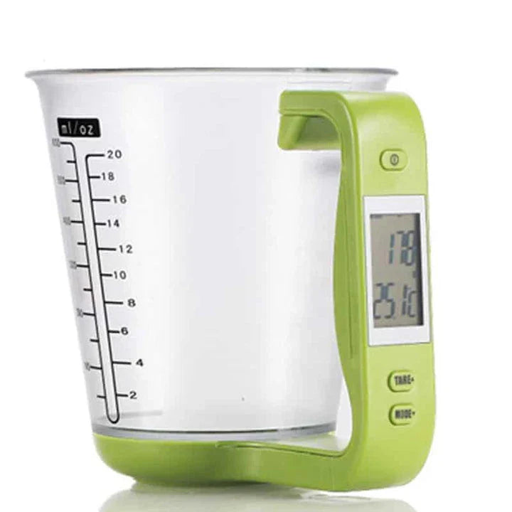 A green digital measuring cup with an LCD display integrated into the handle, designed in New Zealand for precise kitchen measurements